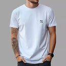 White short sleeve crew neck t-shirt with small black logo on chest worn by tattooed man